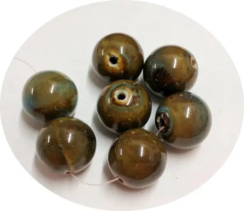 Seven round, glazed brown beads in Dark Honey Aqua Blue ceramic design
