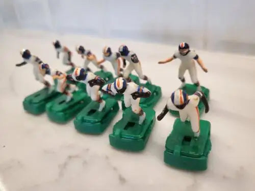 Vintage Denver Broncos electronic football game figures in white uniforms with stands