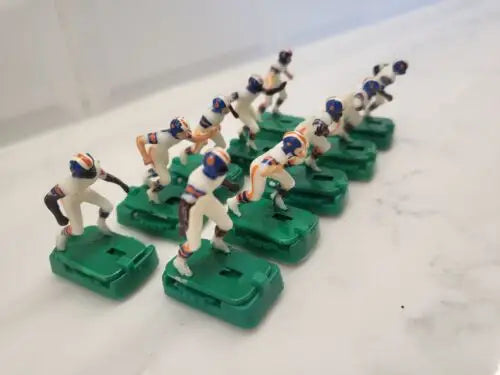 Toy Denver Broncos electronic football players on green bases, vintage style