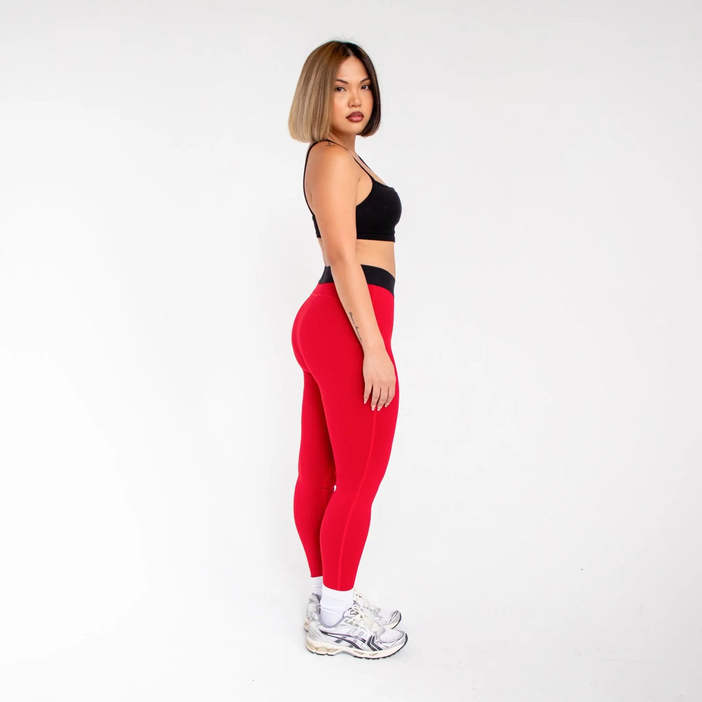 Red leggings with black waistband and white sneakers from 1000BD Women’s Banded Pro Legging info otlapparel