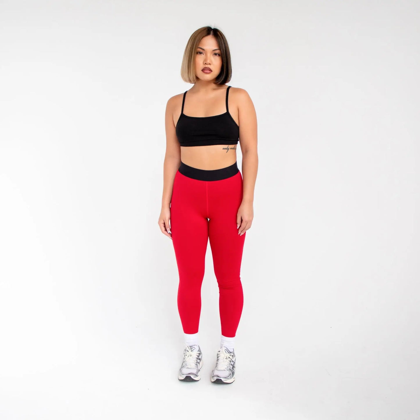 Red leggings with black waistband and white sneakers from 1000BD Women’s Banded Pro Legging info otlapparel
