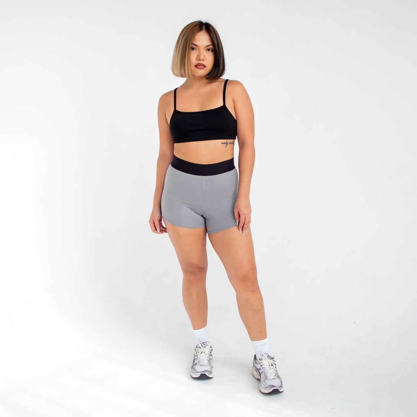 Black and gray sports bra with white straps made of stretchy fabric for women info otlapparel