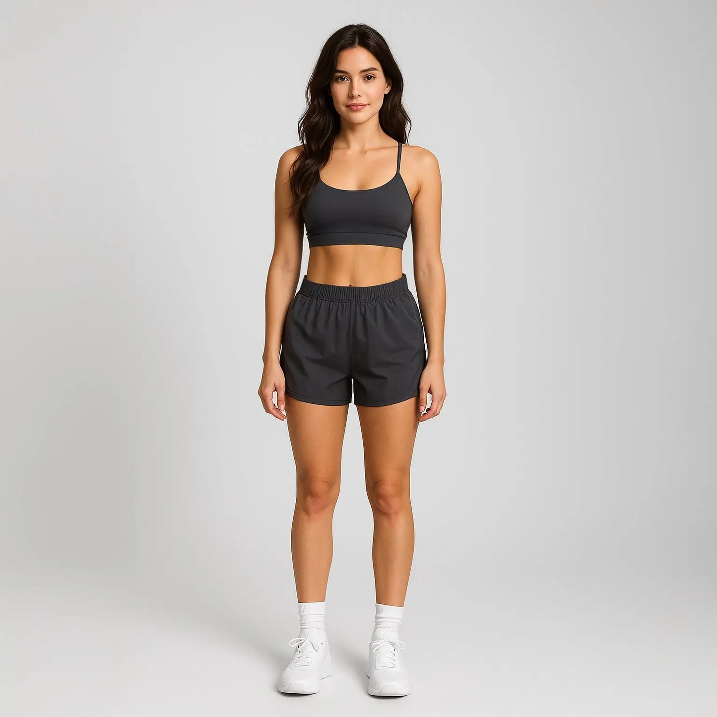 Charcoal gray women’s athletic shorts with elastic waistband and drawstring with white socks