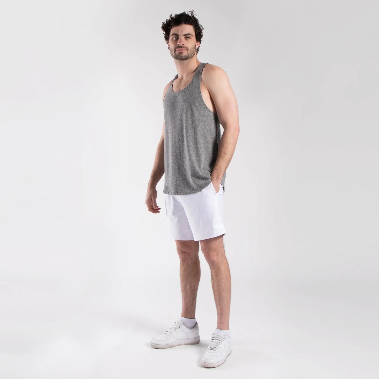 Gray tank top with white athletic shorts and sneakers for men’s athletic shorts