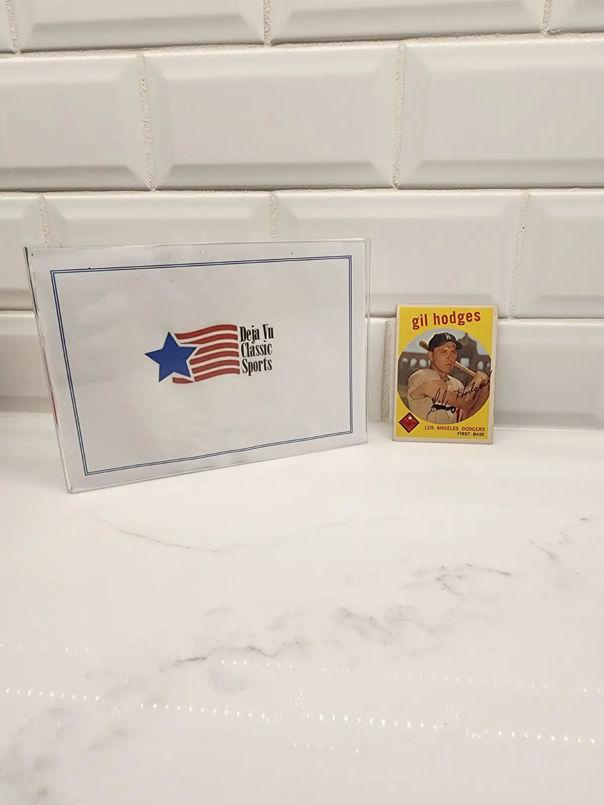 1959 Topps Gil Hodges trading card with sports memorabilia display for collectors