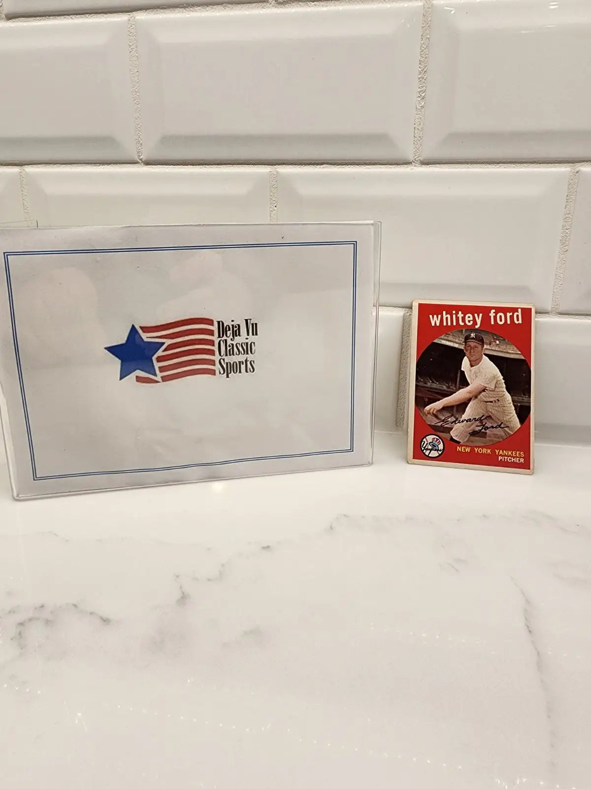Baseball card of Whitey Ford in protective case from 1959 Topps series