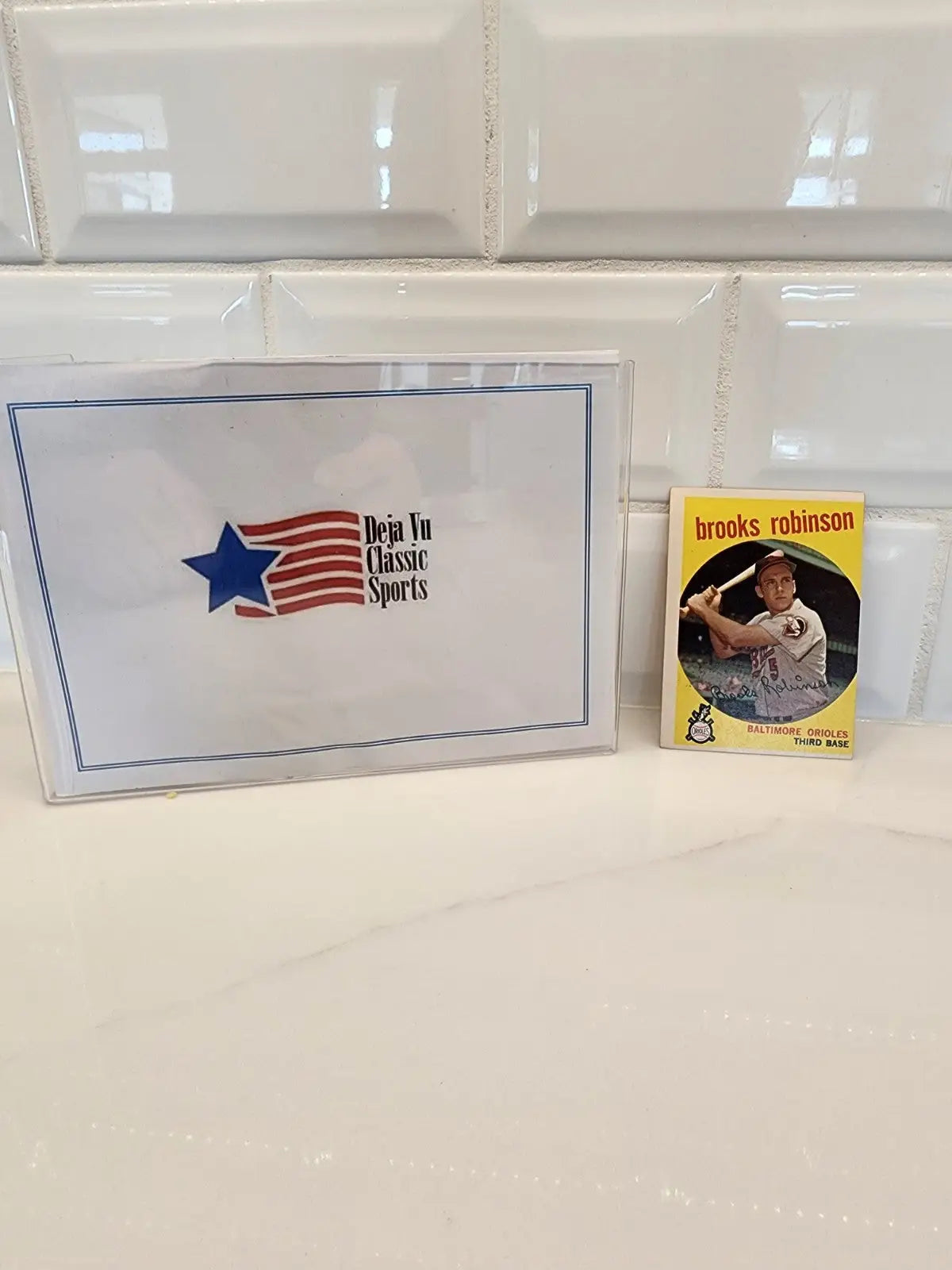 1959 Topps Brooks Robinson trading card with sports memorabilia display