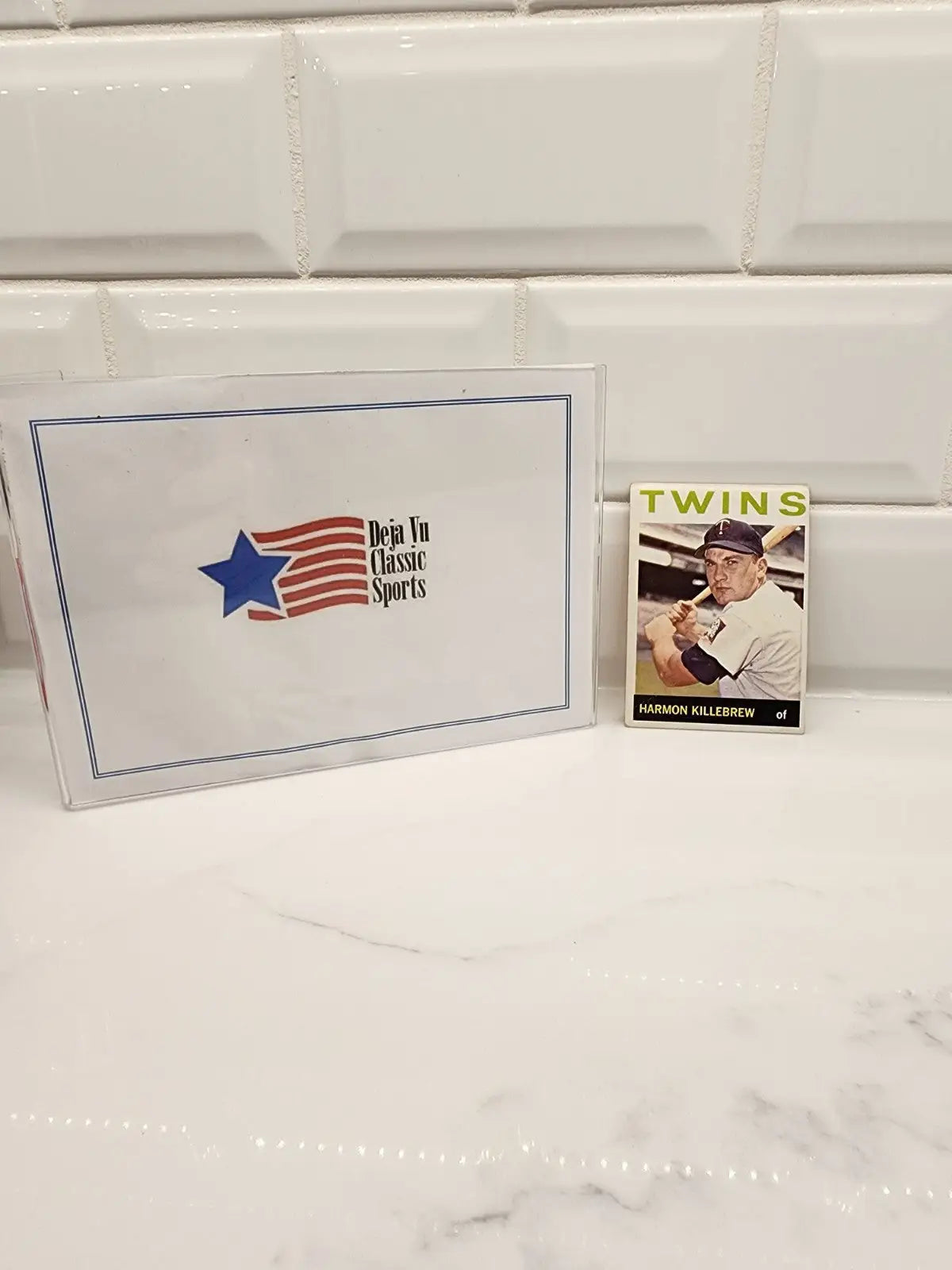Sports memorabilia featuring the 1964 Topps Harmon Killebrew trading card with iconic design