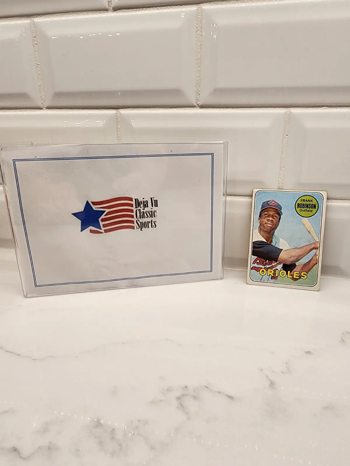 Baseball cards and sports memorabilia box featuring 1969 Topps Frank Robinson trading card
