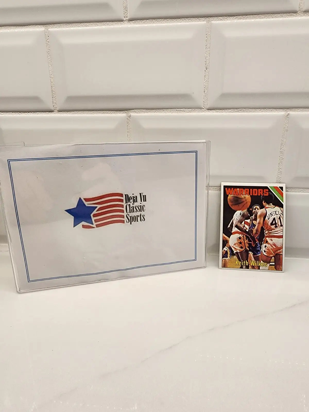 Sports card and box featuring Jamaal Wilkes Golden State Warriors Wilkes rookie card