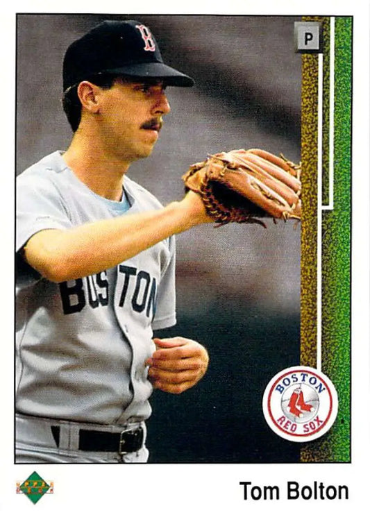 Boston Red Sox player Tom Bolton in road uniform holding a glove for baseball card