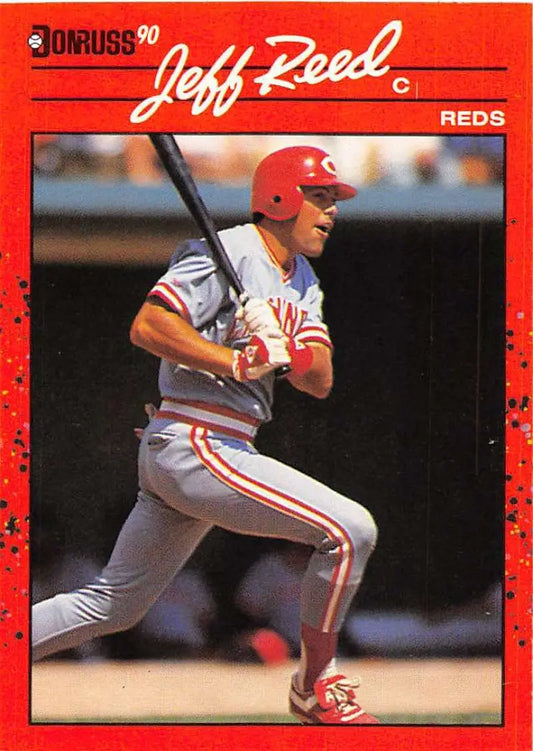 Red-bordered 1990 Donruss baseball card of Jeff Reed batting for Cincinnati Reds