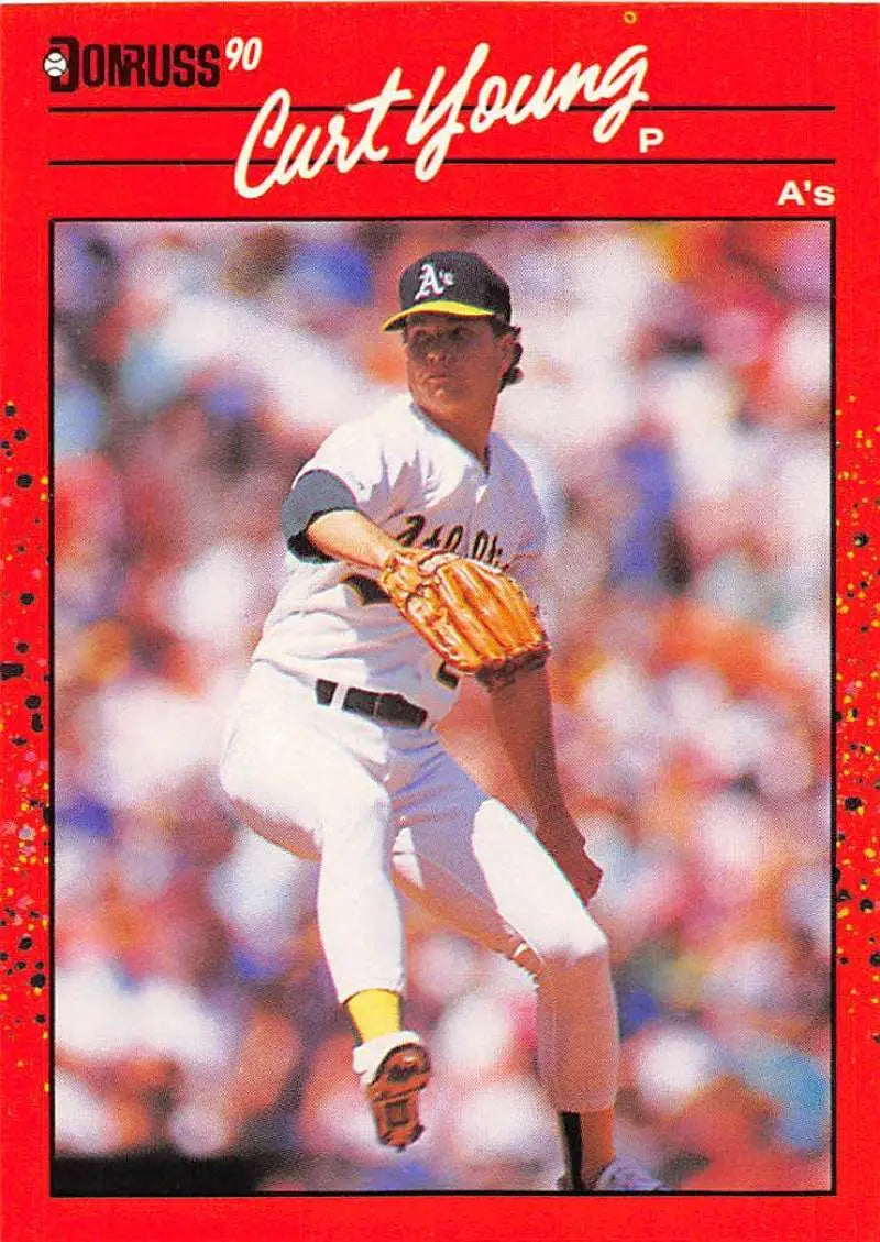 1990 Donruss Curt Young baseball card featuring Oakland Athletics pitcher mid-delivery