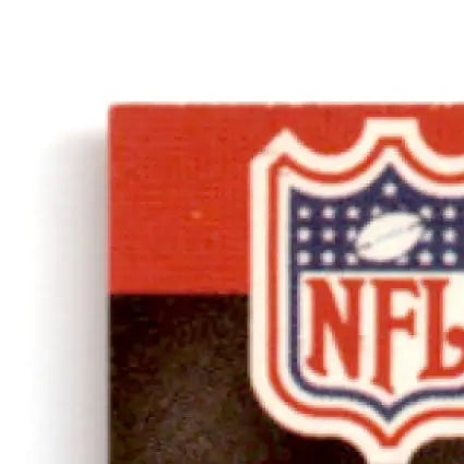 Corner of a red and black NFL logo sticker on 1990 Pro Set Football Steve Young card