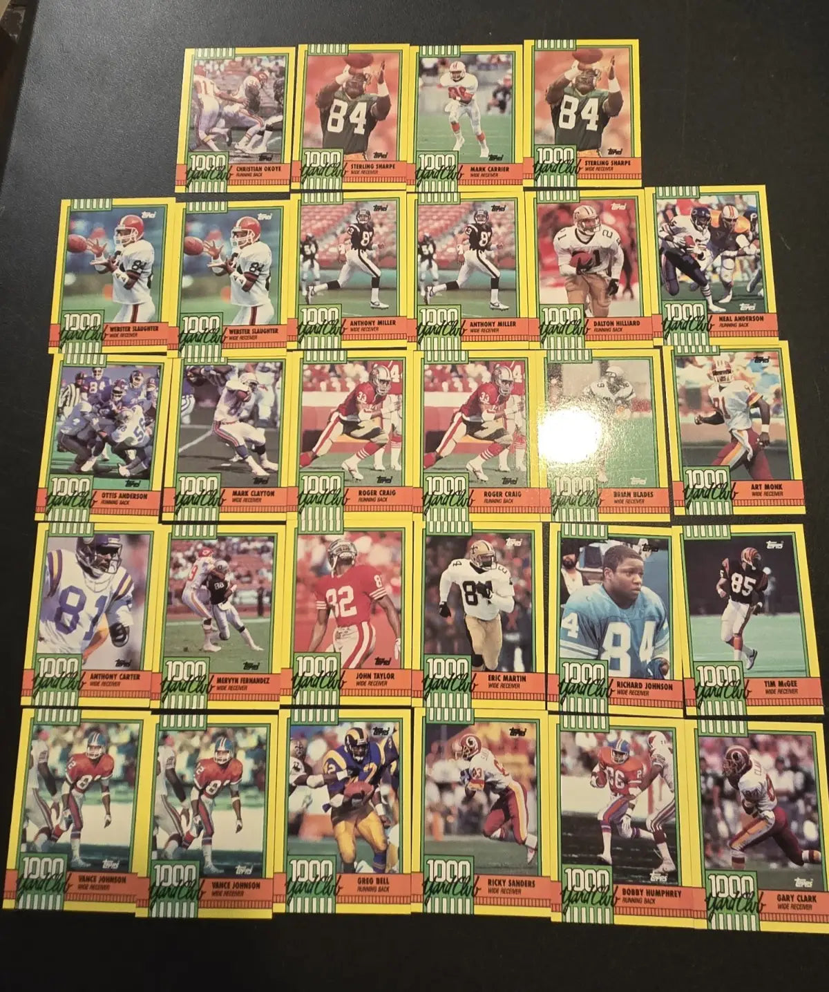 Collection of 1990 Topps Football Yard Club NFL Stars trading cards with yellow borders