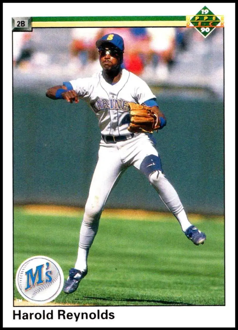 Baseball player Harold Reynolds in a white Seattle Mariners uniform throwing a ball
