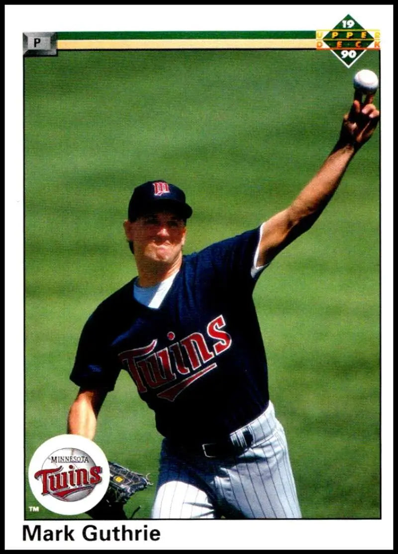 Mark Guthrie catches a ball in his Minnesota Twins navy uniform on this baseball card