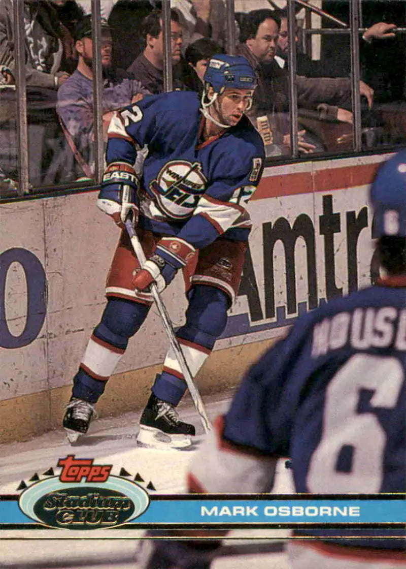 Hockey player in blue jersey skating during game on 1991-92 Topps Stadium Club card