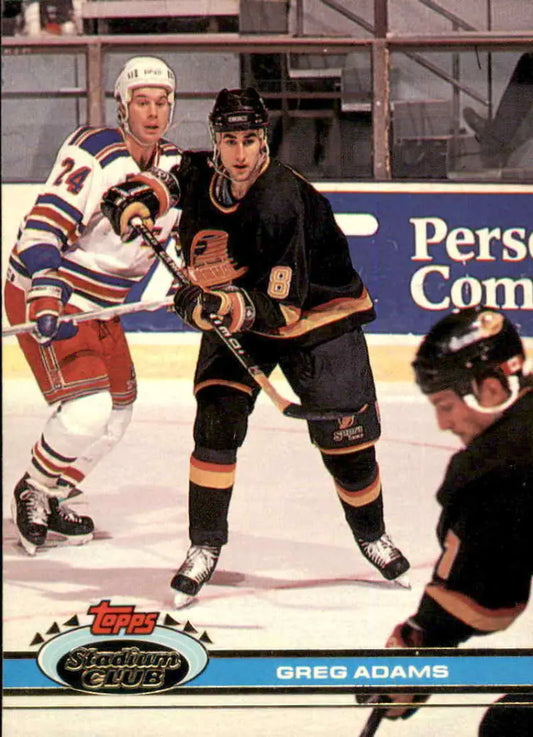 Hockey players competing in a game, showcasing Topps Stadium Club jerseys in action