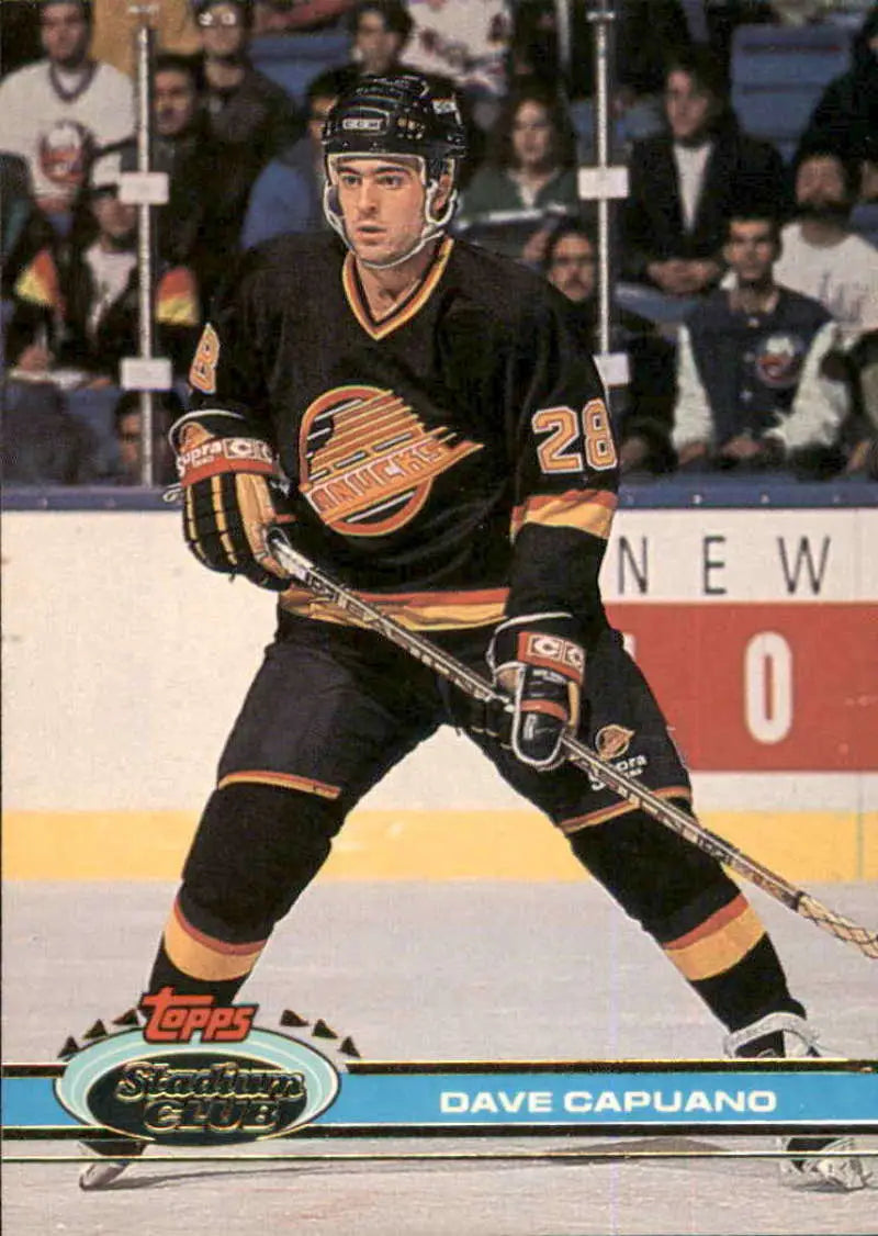 Hockey player in black Vancouver Canucks jersey number 29 Topps Stadium Club hockey card