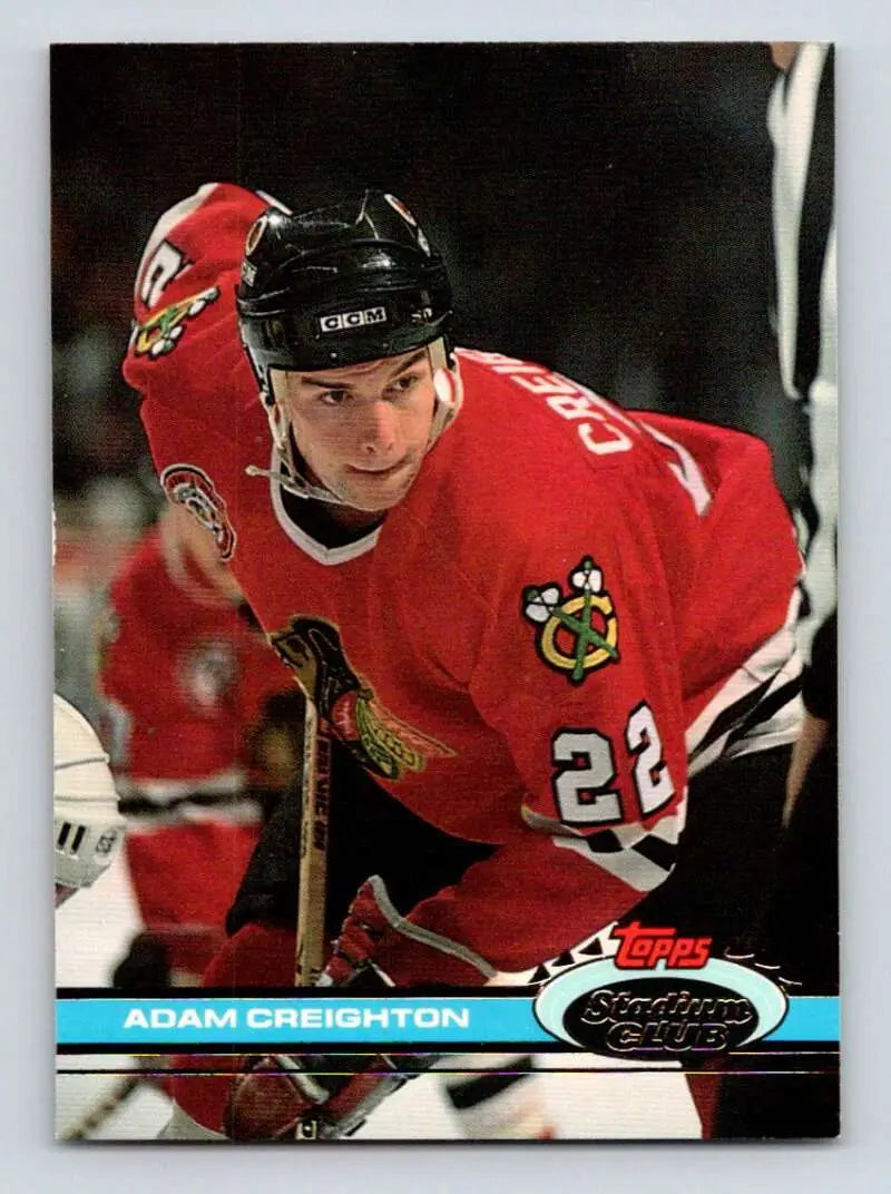 Hockey player in red Chicago Blackhawks jersey number 28 on Topps Stadium Club card