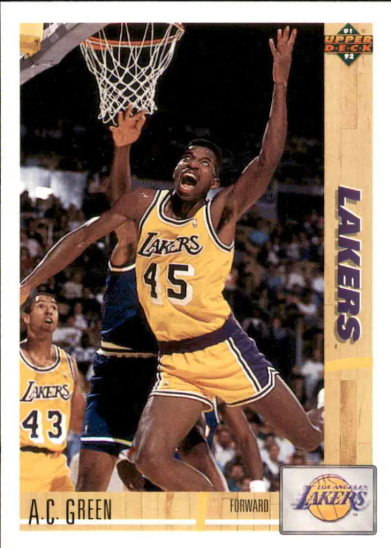 A.C. Green leaps for a basket in his Lakers jersey on a basketball card