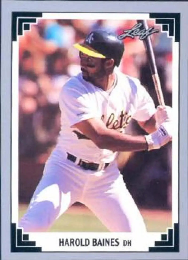 Baseball card of Harold Baines batting for the Oakland Athletics in a white uniform