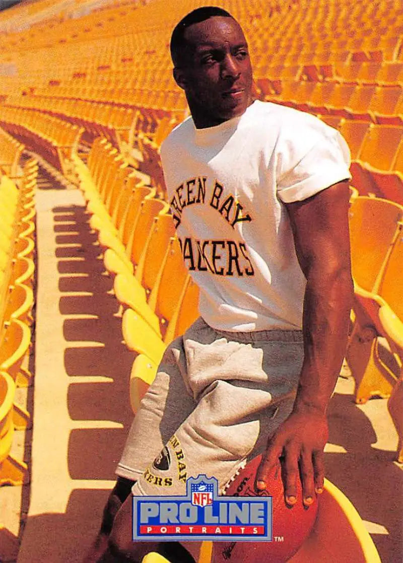 Person in Green Bay Packers t-shirt, light pants, showcasing Vinnie Clark rookie card