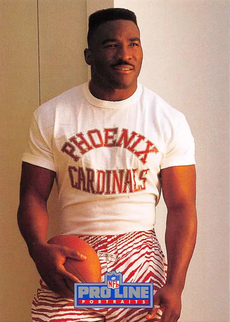Person in white Phoenix Cardinals shirt holding football, featuring Anthony Thompson