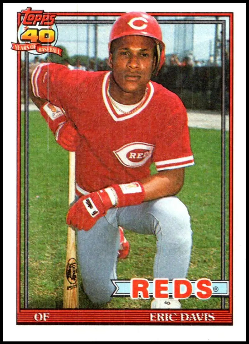 Vintage 1991 Topps baseball card of Eric Davis in Cincinnati Reds red uniform
