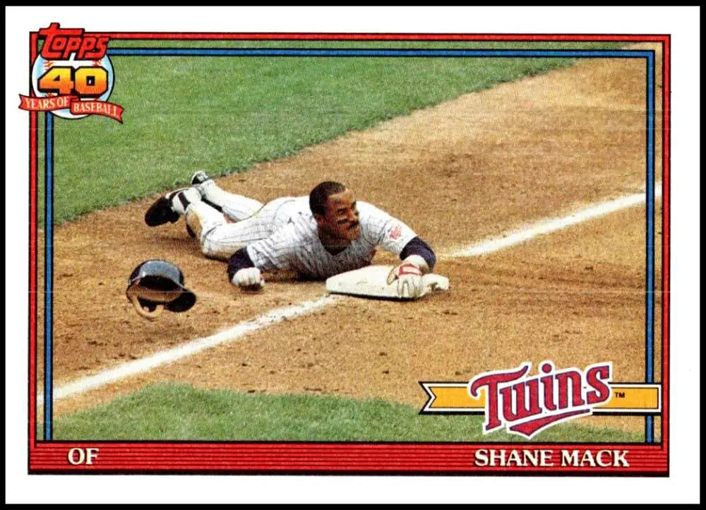 Shane Mack of the Minnesota Twins sliding headfirst into a base in a baseball game