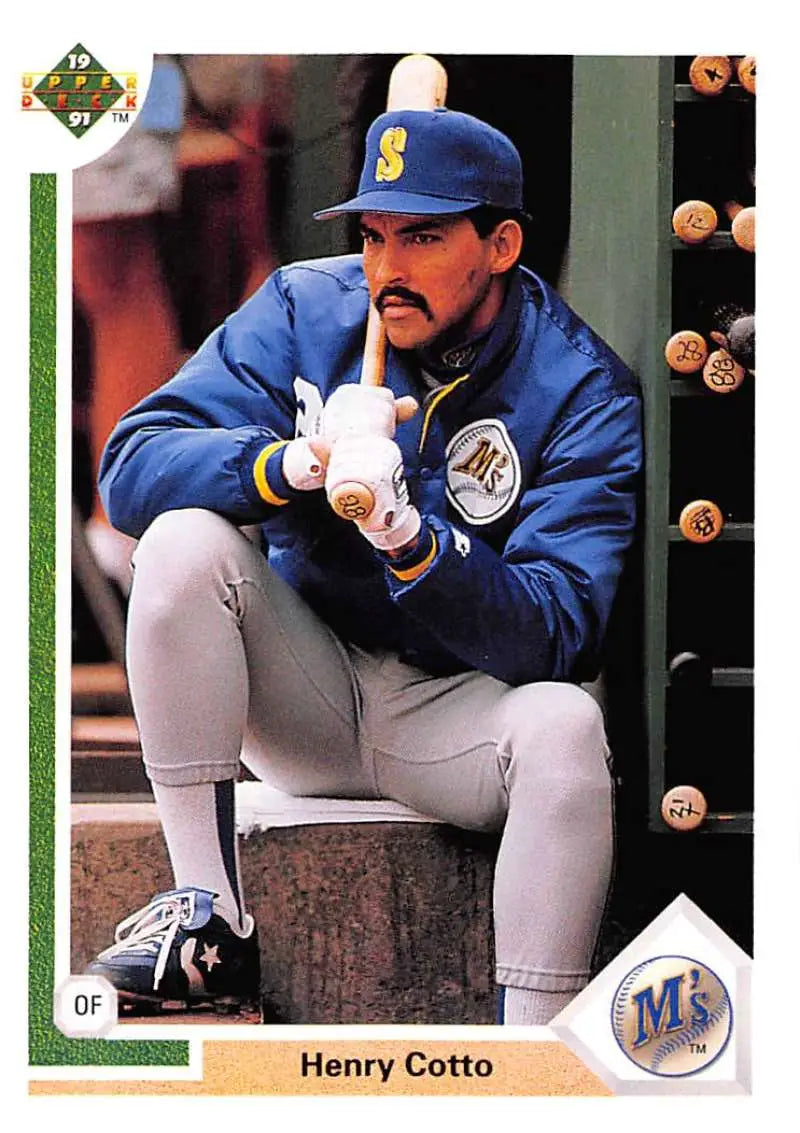Baseball player Henry Cotto in Seattle Mariners uniform crouches in dugout
