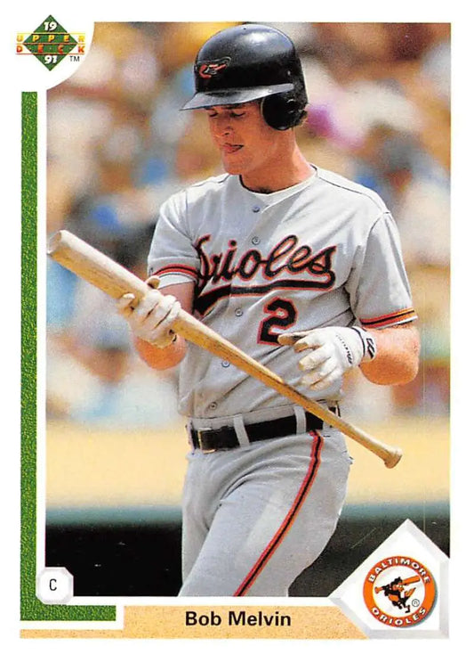 Baseball card of Bob Melvin in gray Baltimore Orioles uniform holding a bat