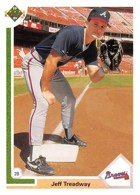 Baseball player Jeff Treadway in Atlanta Braves uniform fielding stance on baseball card