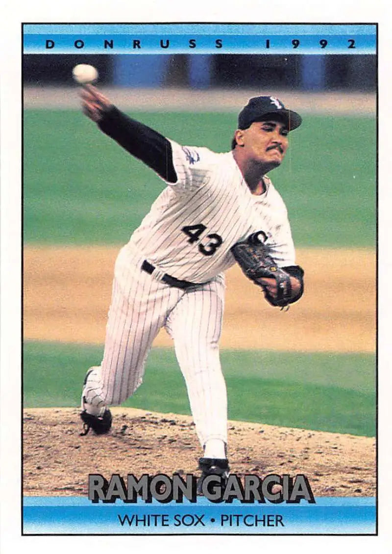 Baseball pitcher Ramon Garcia in White Sox pinstripes delivering a pitch