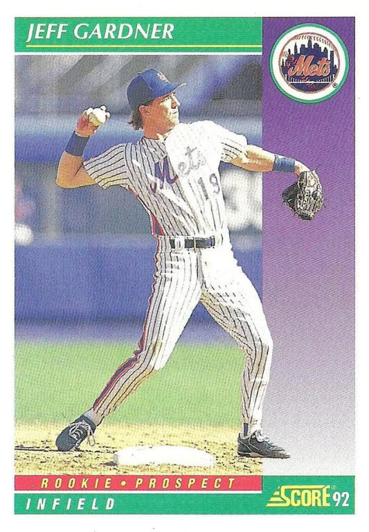 Baseball player Jeff Gardner in New York Mets pinstripe uniform throwing ball