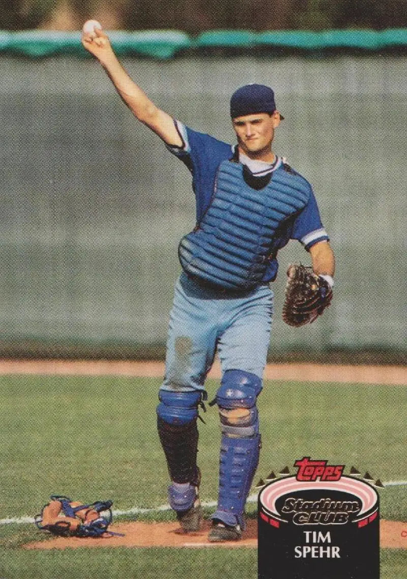 Tim Spehr in blue uniform throwing from behind home plate for Kansas City Royals