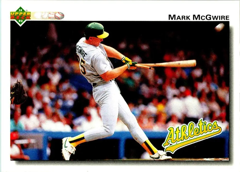 Baseball player in white Oakland Athletics uniform swinging bat for Mark McGwire card