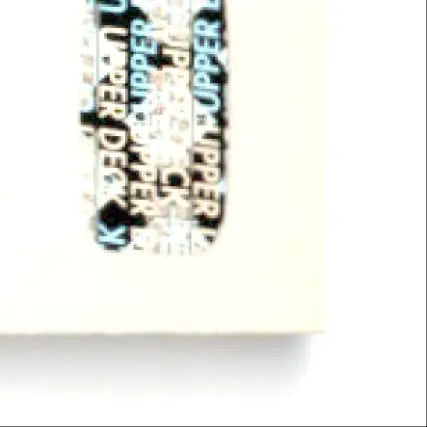 Black and white upper deck hockey sticker of Theoren Fleury rated rookie on plastic surface