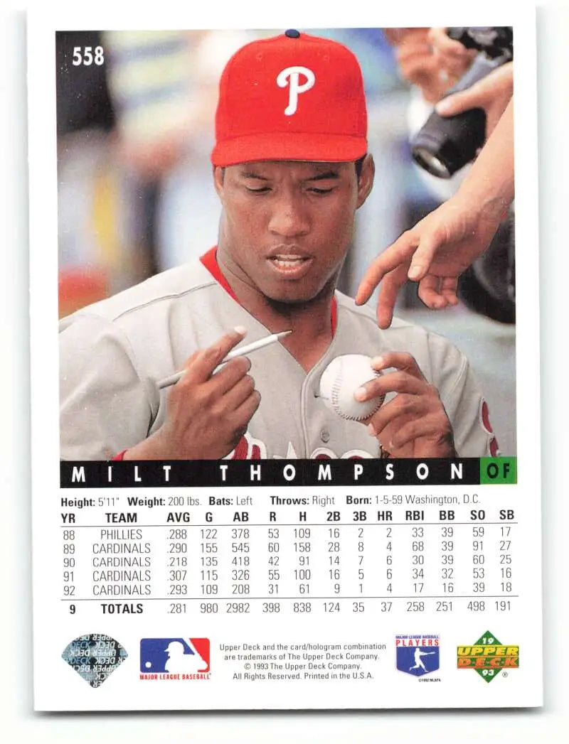 Milt Thompson signing a baseball on a 1993 Upper Deck Philadelphia Phillies card