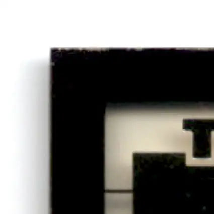Fragment of a dark rectangular picture frame with white border from 1994 Collector’s Edge Steve Young Boss Squad Silver #5 49ers