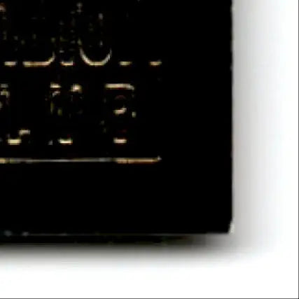 Black electronic component with gold markings for Topps Football Stadium Club Steve Young card