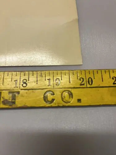 Yellow measuring tape beside 1996 Star Trek Uncut Sheet of 9 trading cards