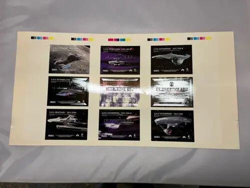 Uncut sheet of 9 Star Trek trading cards featuring iconic ships in gold foil design