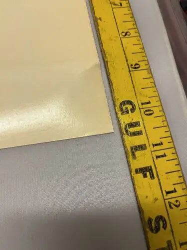 Yellow measuring tape alongside 1996 Star Trek Uncut Sheet of trading cards