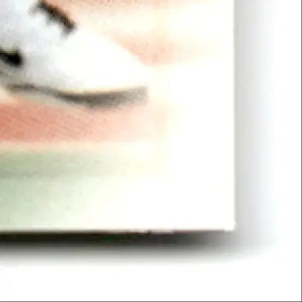 White shoe with dark accents on striped background for Leaf Football Andre Reed #37
