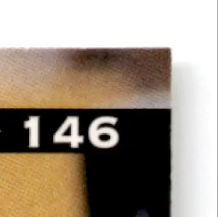 Part of a numbered wooden block with dark band from Leaf Football Derrick Alexander card