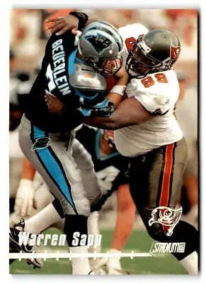 Football players in action featuring Warren Sapp from the 1999 Stadium Club trading cards