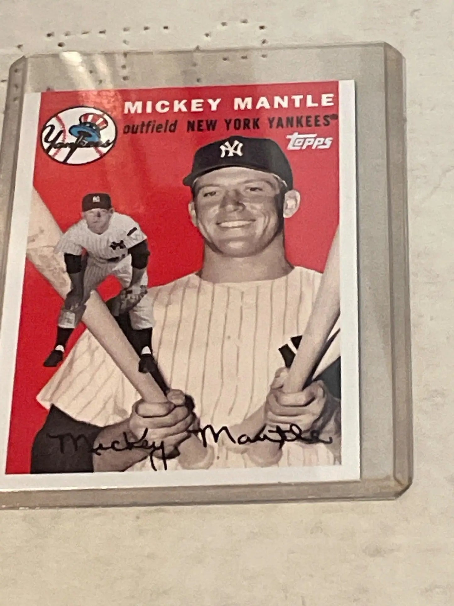 Vintage New York Yankees baseball card of Mickey Mantle in pinstripes with bats