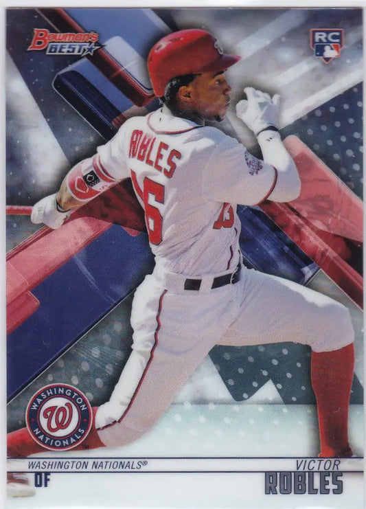 Baseball player Victor Robles in white Washington Nationals uniform swinging bat